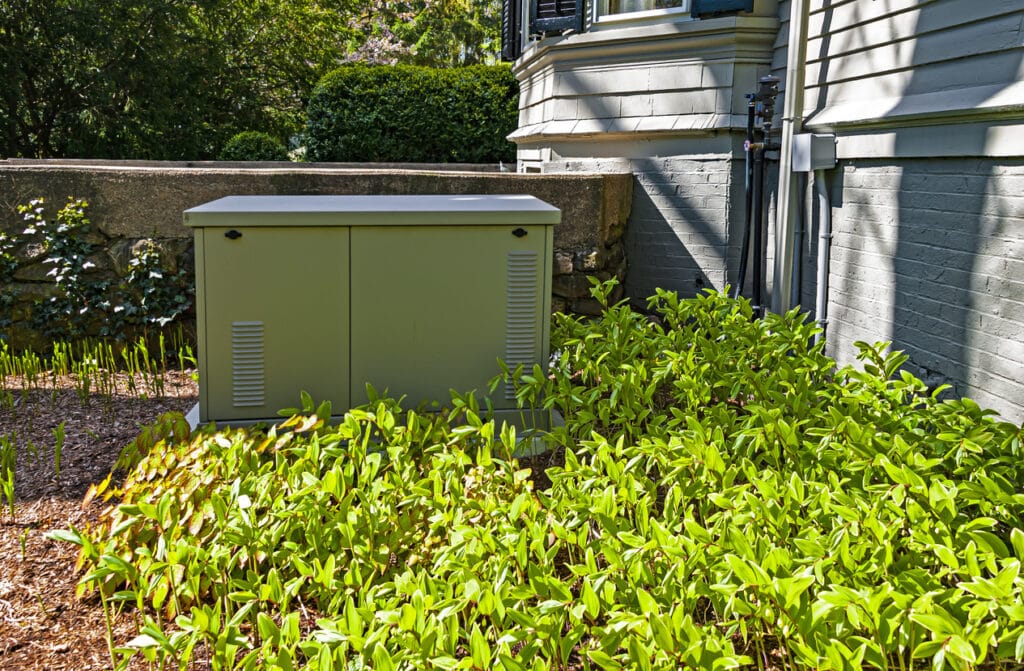 Residential standby generator installed on a concrete pad