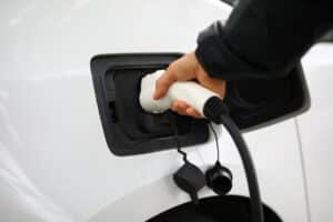 inserts electric charger into vehicle